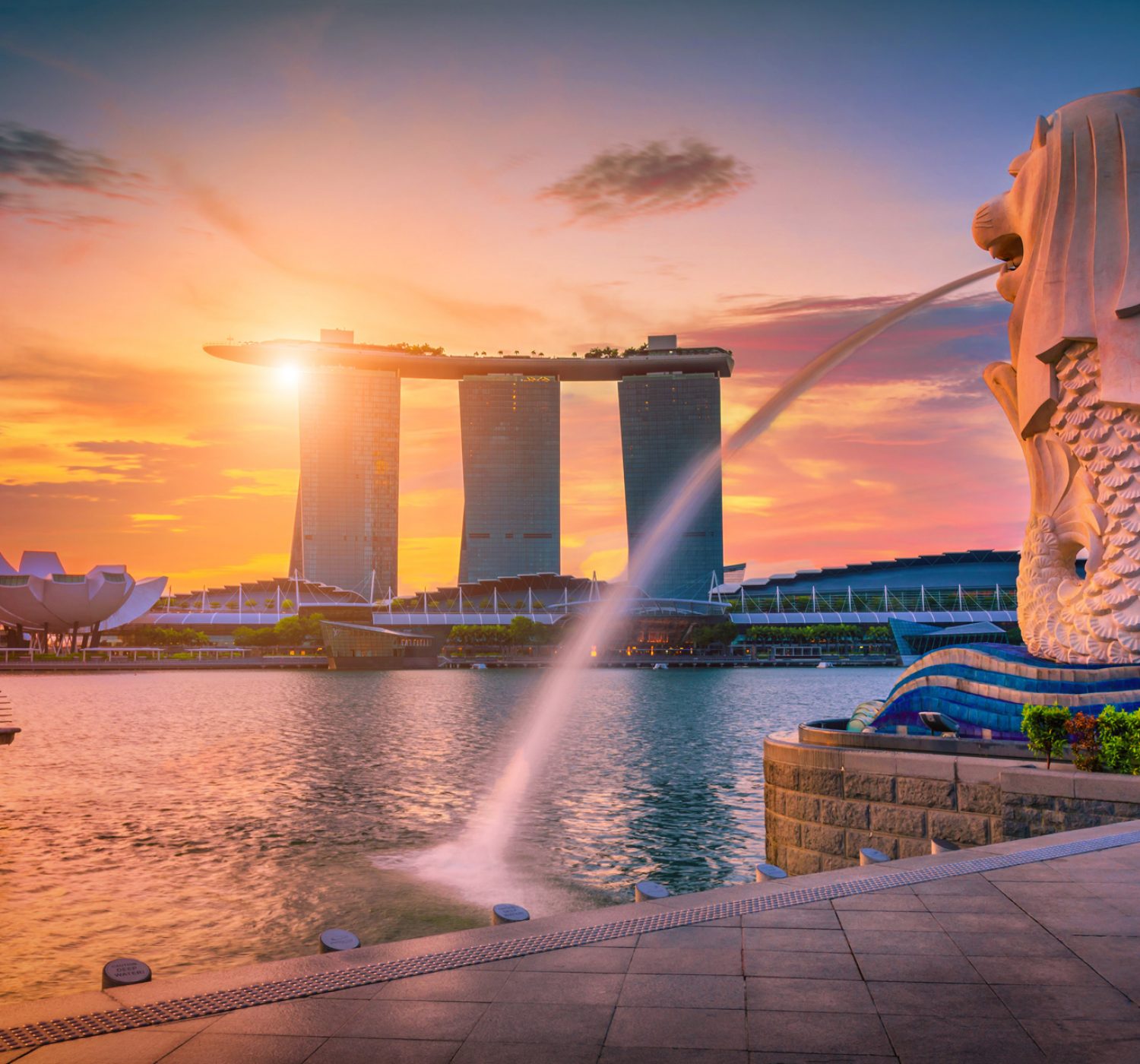 SINGAPORE-JULY 9, 2016: Merlion statue fountain in Merlion Park SINGAPORE-JULY 9, 2016: Merlion statue fountain in Merlion Park and Singapore city skyline at sunrise on July 9, 2016. Merlion fountain is one of the most famous tourist attraction in Singapore.
